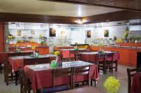 a dining room with tables and chairs in a restaurant at JR Hotel in João Pessoa