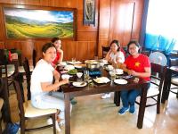 a group of women sitting around a table in a restaurant at Sapa Sweet Time Hotel in Sa Pa