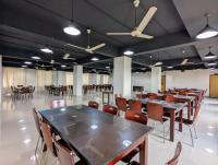 een conferentieruimte met tafels en stoelen erin bij YMCA Training Center and Guest House 