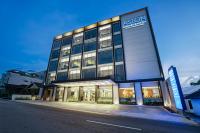 Un edificio con un cartel al costado. en Aston Emidary Bangka Hotel and Conference Center, en Pangkalpinang