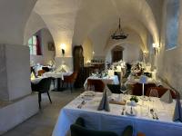 a restaurant with tables with white table cloths and chairs at Hotel & Spa Wasserschloss Westerburg in Westerburg