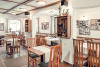 a restaurant with wooden tables and chairs in a room at Complex Popangelov in Borovets