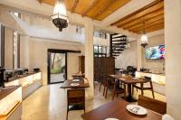 Una cocina y un comedor con mesas y sillas. en Dewan Bangkok, en Bangkok