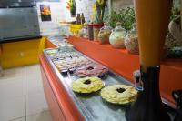 a counter with donuts and other pastries on at JR Hotel in João Pessoa