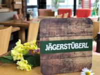 a sign sitting on top of a table with flowers at DAHUAM SUITES GERLOS Ski in Appartements mit BalkonITerrasse in Gerlos