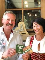 a man and a woman holding a bar of food at DAHUAM SUITES GERLOS Ski in Appartements mit BalkonITerrasse in Gerlos