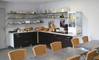 a kitchen with a counter with tables and chairs at Hotel Bleu Azur in Argelès-sur-Mer