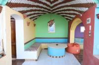 a room with a table in the middle of a room at Ekadolli Nubian house- by kerma hospitality in Aswan
