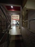 a hallway of a building with a sign that reads restaurant at Starline Hotel in Agartala