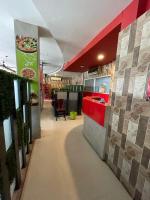 a restaurant with a counter and a pizza restaurant at Starline Hotel in Agartala