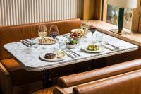 a table with plates of food and glasses of wine at La Fondation in Paris