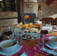 een tafel met eet- en wijnglazen en een open haard bij The Waterfall Free Parking in Balchik