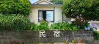 a house with flowers in front of it at Izu Hokkawa Seaside Guesthouse 伊豆北川の家 in Higashiizu