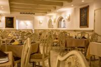 a dining room with tables and chairs and tablesktop at Osborne Hotel in Valletta