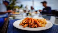 a white plate of food on a table at Castelo Beach Resort in Inhambane