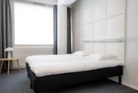 a bedroom with a large bed and a window at Omena Hotel Joensuu in Joensuu
