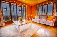una sala de estar con un sofá y una mesa en Chalet 6 personnes avec sauna, en Leysin