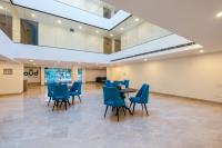 una sala de reuniones con sillas azules y una mesa en Limewood Signature - Golf Course Extension Road, en Gurgaon