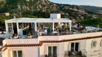 a balcony of a building with people sitting at tables at Dolce Vita Boutique Hotel in Porto Cervo