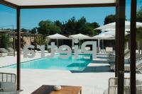 a swimming pool with umbrellas and a sign that reads study at Masseria Corsano in Nardò