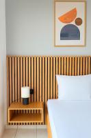 a bedroom with a bed and a table with a lamp at Harmonia Himara in Himare