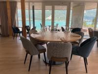 a dining room with a table and chairs with a view at Le Rossignol in Annecy