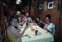 a group of people sitting around a table drinking beer at Hotel El Recreo Lanquín-Champey in Lanquín