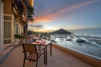 a balcony with a table and chairs and a view of the ocean at Centara Villas Phi Phi Island in Phi Phi Don
