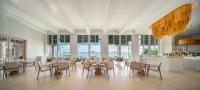 a dining room with tables and chairs and windows at Centara Villas Phi Phi Island in Phi Phi Don