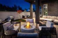 a fire pit on a patio with chairs and tables at Hyatt Place Cape Canaveral in Cape Canaveral