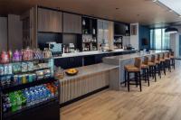 a bar with bar stools and bottles of soda at Hyatt Place Cape Canaveral in Cape Canaveral
