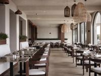 een rij tafels en stoelen in een restaurant bij Stella Blue Seaside Resort in Chersonissos