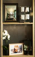a shelf with two mirrors and a picture and flowers at Handsome Hotel in Paris