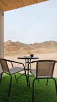 2 Stühle, ein Tisch, ein Tisch und Stühle in der Unterkunft Wonder Elat in Eilat