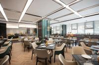 ein Restaurant mit Tischen und Stühlen und eine Cafeteria in der Unterkunft 上海浦东温德姆花园酒店 Wyndham Garden Shanghai Pudong in Huinan