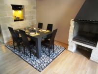 a dining room with a table and chairs and a fireplace at Les toîts d&#39;Uzès in Uzès