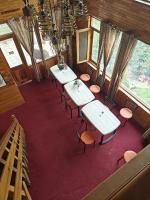 an overhead view of a room with tables and chairs at Apple Garden Cottage in Manāli