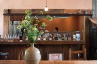 a vase of flowers on a table in a restaurant at NOTEL Stay in a farming village in Tonosho