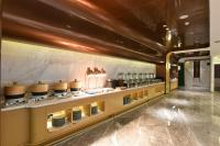a restaurant with a counter with dishes on it at Atour Hotel Dalian Hi-tech Zone in Dalian