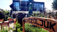 a sign in front of a house with a building at Sarokhaz Panzio in Vecsés