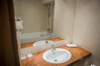 a bathroom with a sink and a mirror at Hotel Arnia in Iaşi