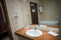 a bathroom with a sink and a bath tub at Hotel Arnia in Iaşi