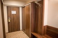 a corridor with a wooden door in a room at Hotel Arnia in Iaşi
