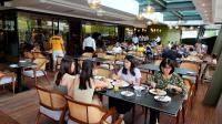 a group of women sitting at tables in a restaurant at 1969 D'Kelly Hotel in Ipoh