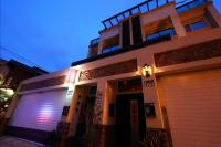 a building with two garage doors in front of it at Shanghai Time in Hualien City