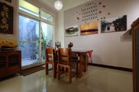 a dining room with a table and chairs and a window at Shanghai Time in Hualien City