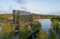 an aerial view of a building next to a lake at Hernö Gin Hotell in Härnösand