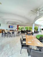 un ristorante con tavoli e sedie e un bar di Oceanfront Condo in Ixtapa, Zihuatanejo a Ixtapa