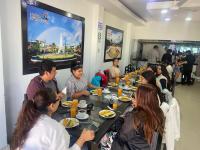 a group of people sitting at a table eating food at COSTA AZUL in Tarapoto