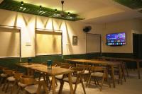 a dining room with tables and chairs and a tv at Grihum Living Girls - FEMALE ONLY in Rānchī